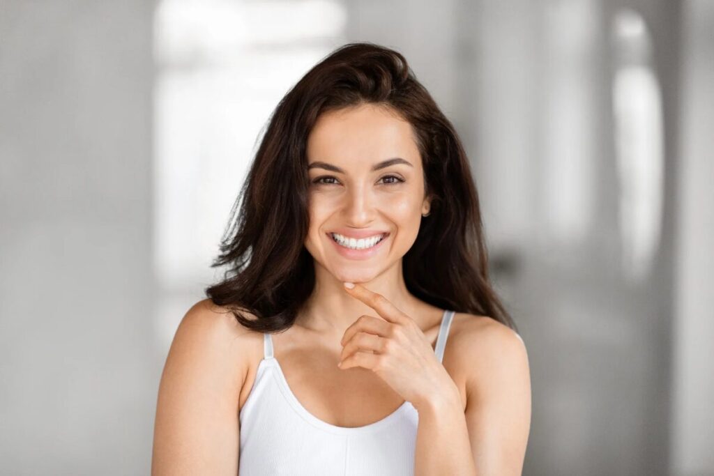 Radiant woman smiling with confidence in the bathroom.