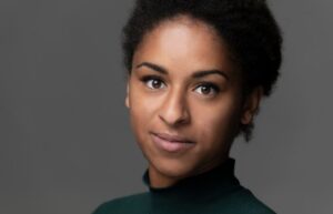 Beautiful young curly haired black woman's face. How to build confidence for personal growth.