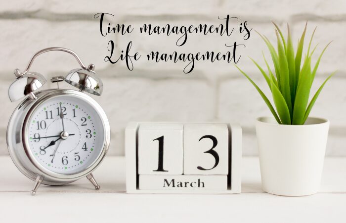 A desk with an alarm clock, a potted plant, a calendar and a phrase of Time is management is Life management. Transform your tension: Unlocking strategies the secrets to effortless stress management.